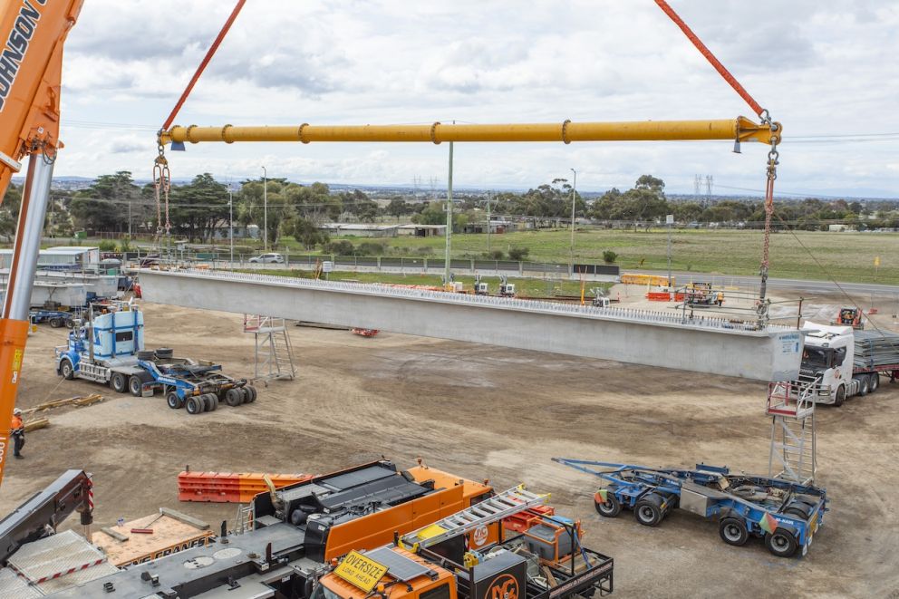 The remaining beams are lifted into place that will form the new Hopkins Road bridge