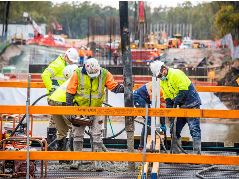 Image of construction workers pouring concrete