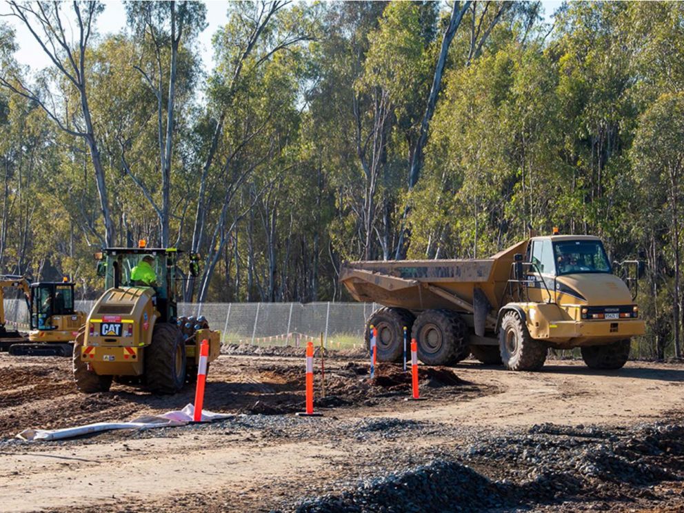 Image of 3 yellow vehicles moving earth during the stage 3 construction.
