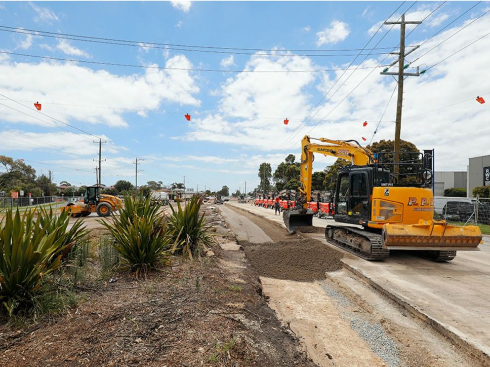 Works to build the new lanes on Wells Road with multiple construction vehicles scattered through the image