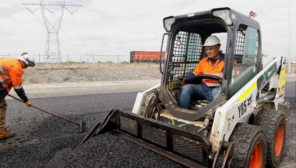 Laying the final coat of asphalt to build the new entry and exit ramps from O’Herns Road