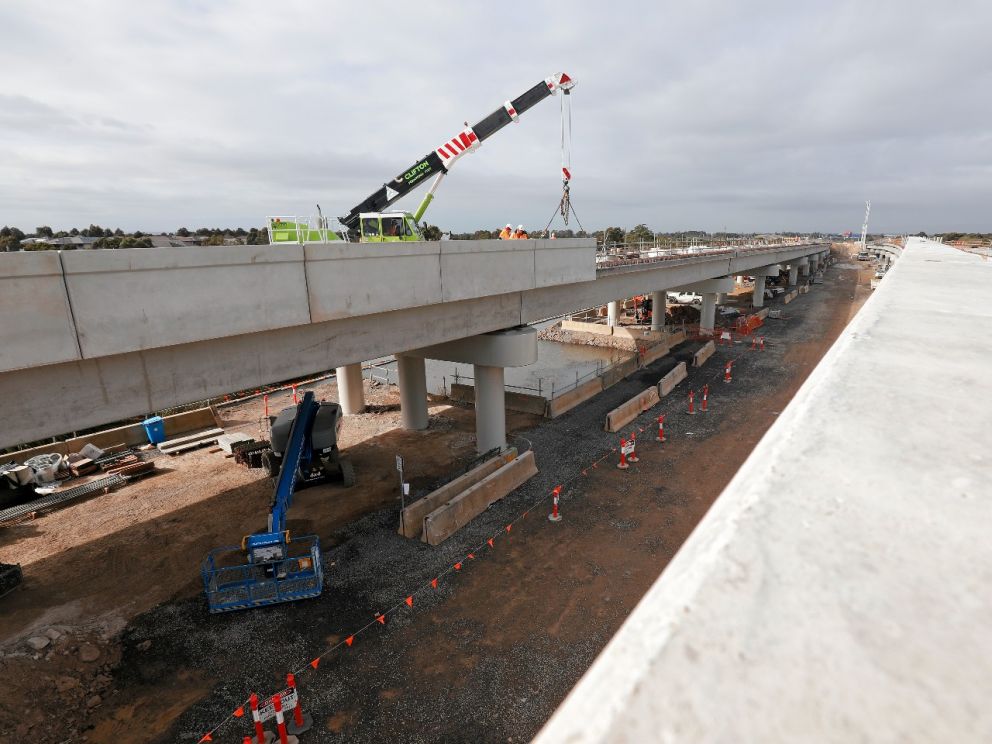 Installing barriers along the side of the 400-metre twin bridges over the Waterways wetlands