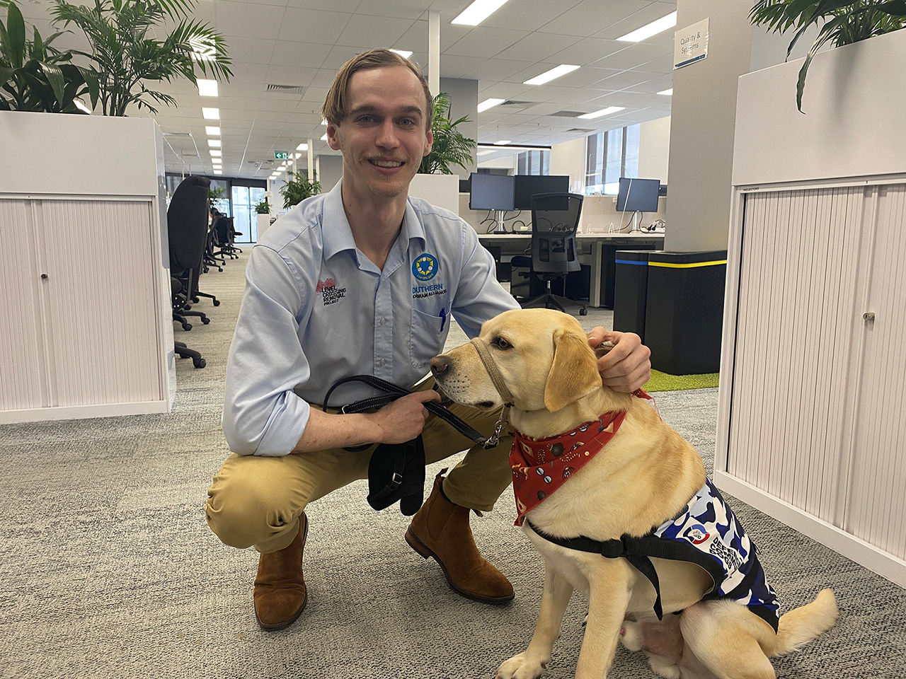LXRP staff Tom with service dog Bruce in the office