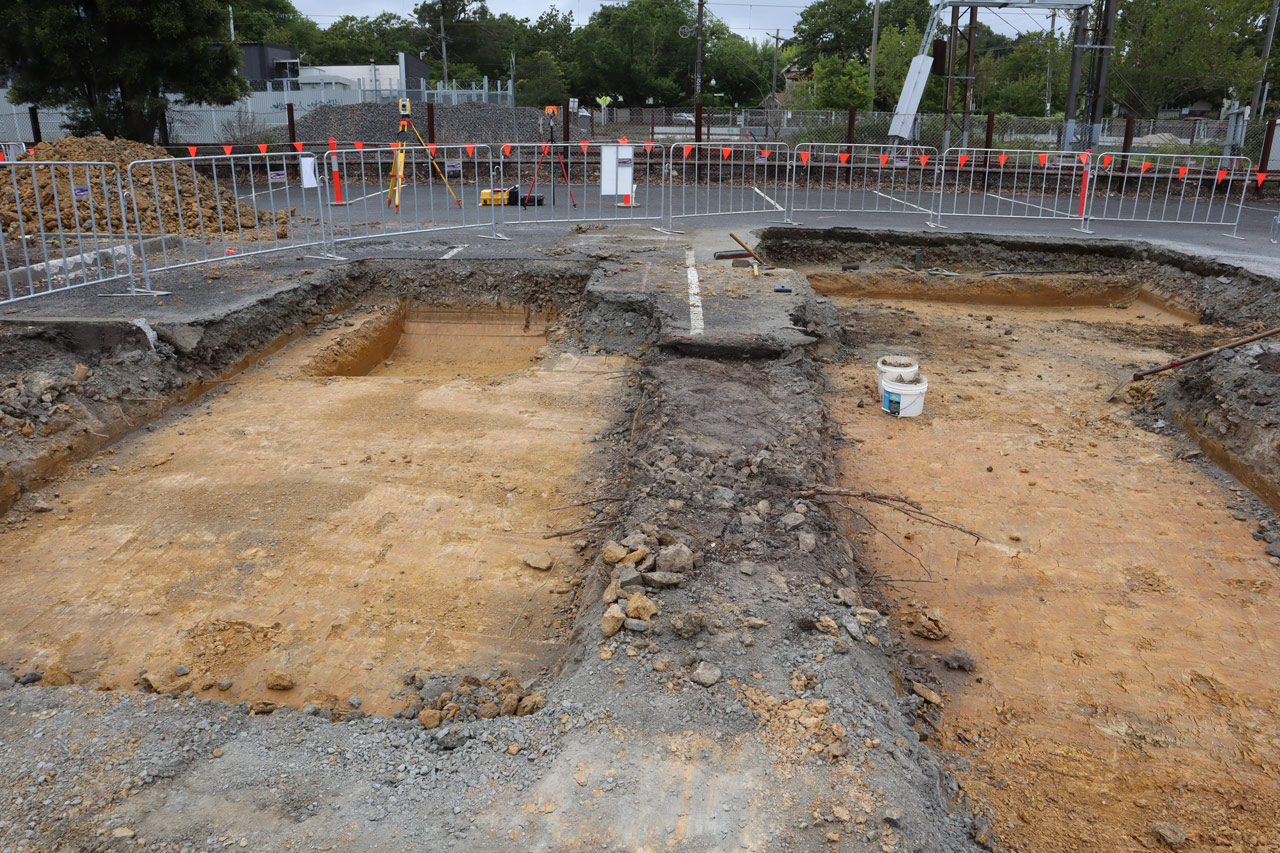 Two shallow pits dug in the car park at Surrey Hills Station.