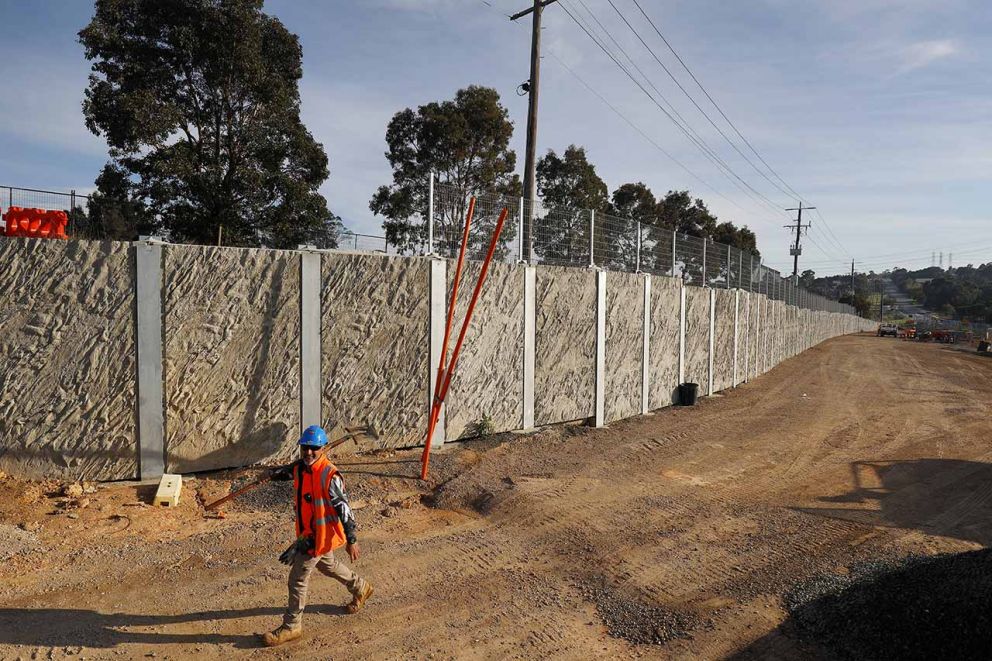 Post and panel retaining wall 