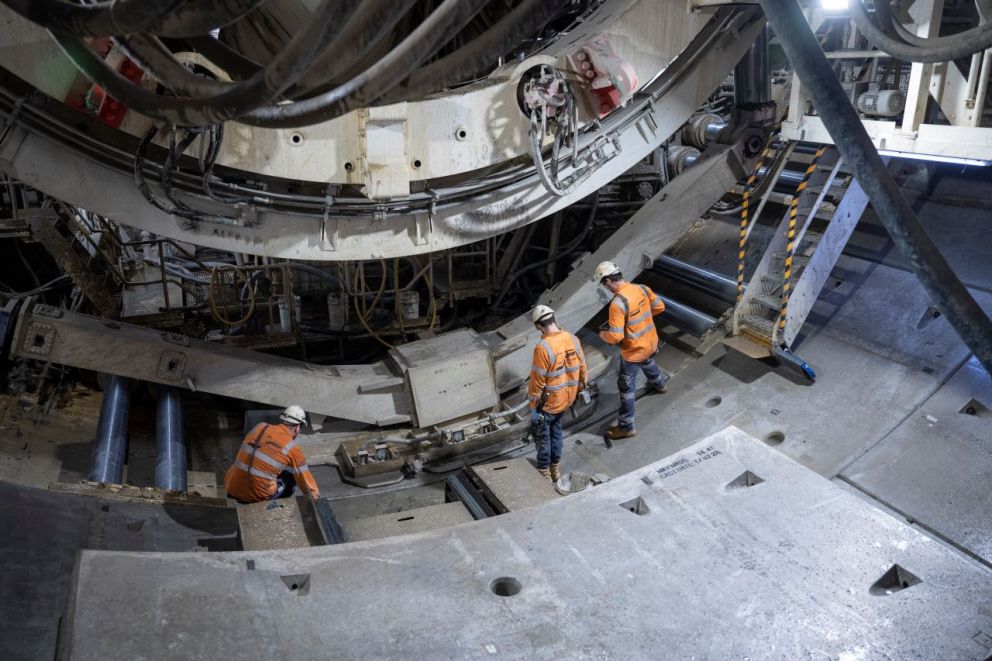 Workers examining the lined segments.