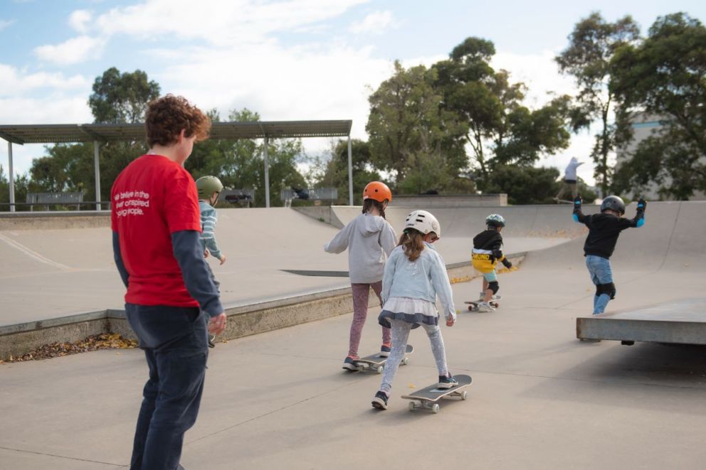 YMCA All Aboard participants practicing on the skate ramp.