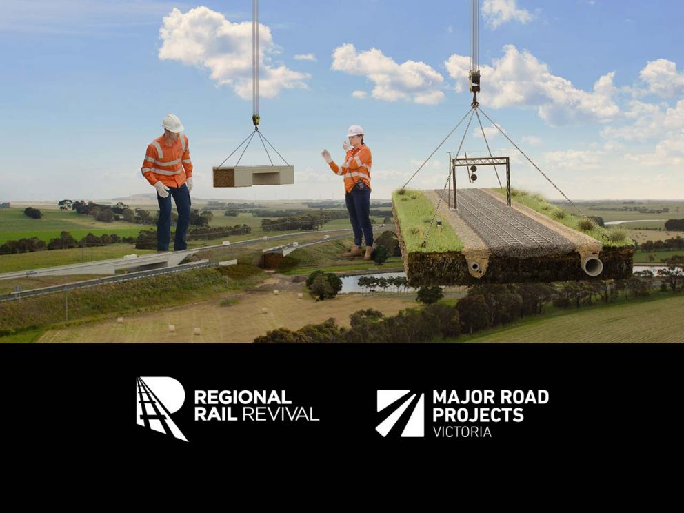 Rural landscape, with giant segment of railway being craned into place by two workers in high-vis shirts and hard hats. Logos for Regional Rail Revival and Major Road Projects Victoria.