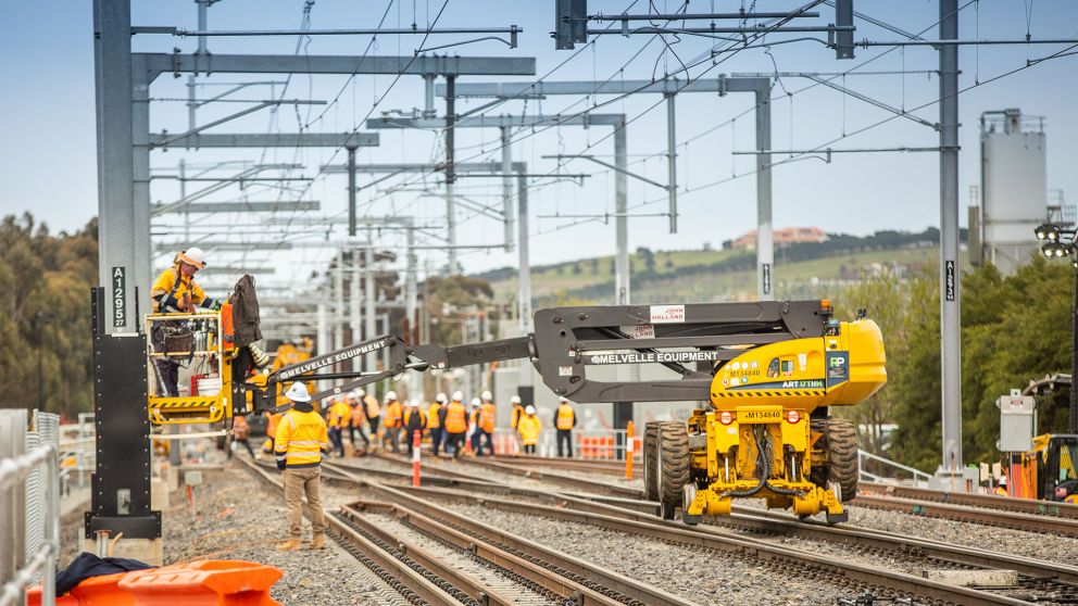 Workers working on an outdoor rail line