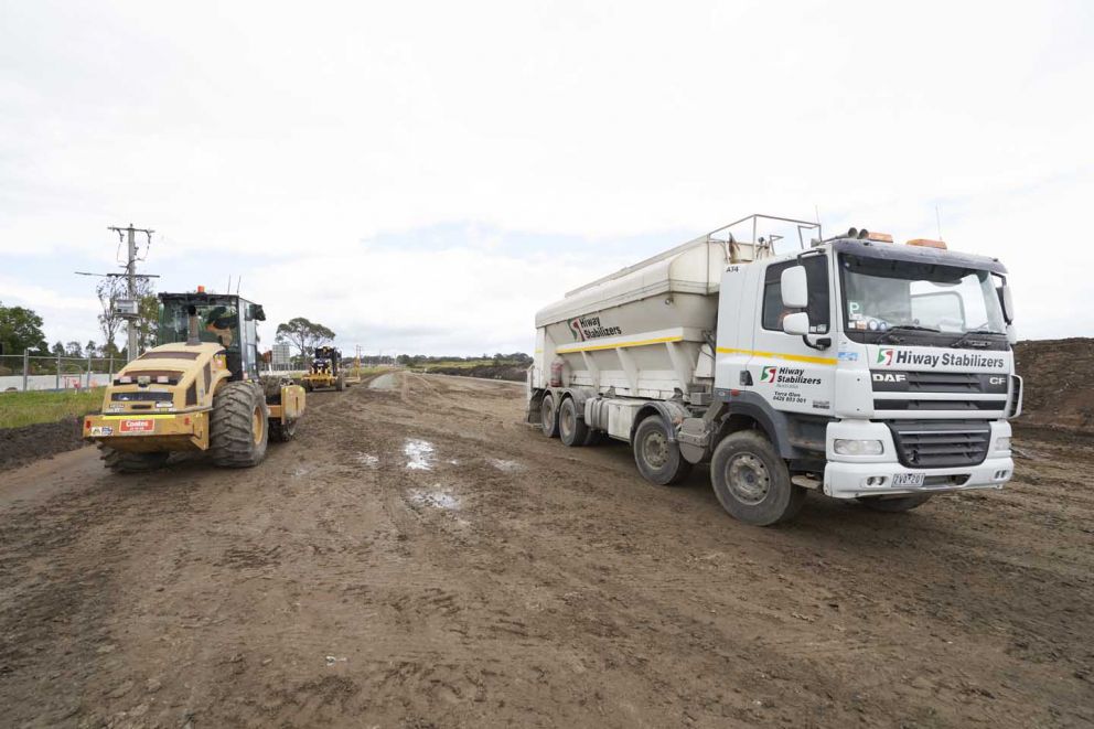 Works taking place behind barriers to build the new eastbound lanes on Hall Road near the Western Port Highway intersection