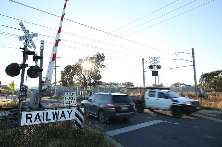 Cars crossing the level crossing at Station Street, Officer