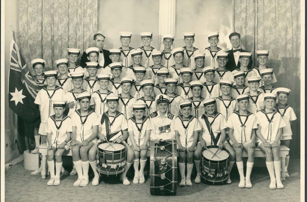 Class photo of young boys and their drum kits
