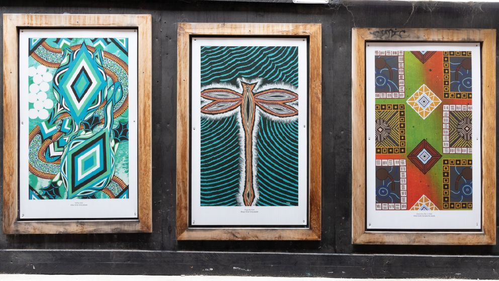Image of three wooden frames displaying artworks by First Nations artists