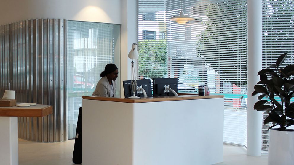 A person standing at a reception desk in the North East Link skills and training centre.