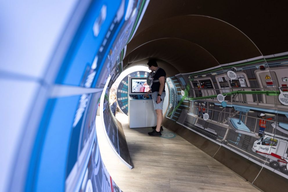 An Info Centre visitor checking out the Tunnel Boring Machine model