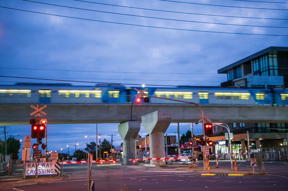 A train runs on the new city bound rail bridge over Keon Parade