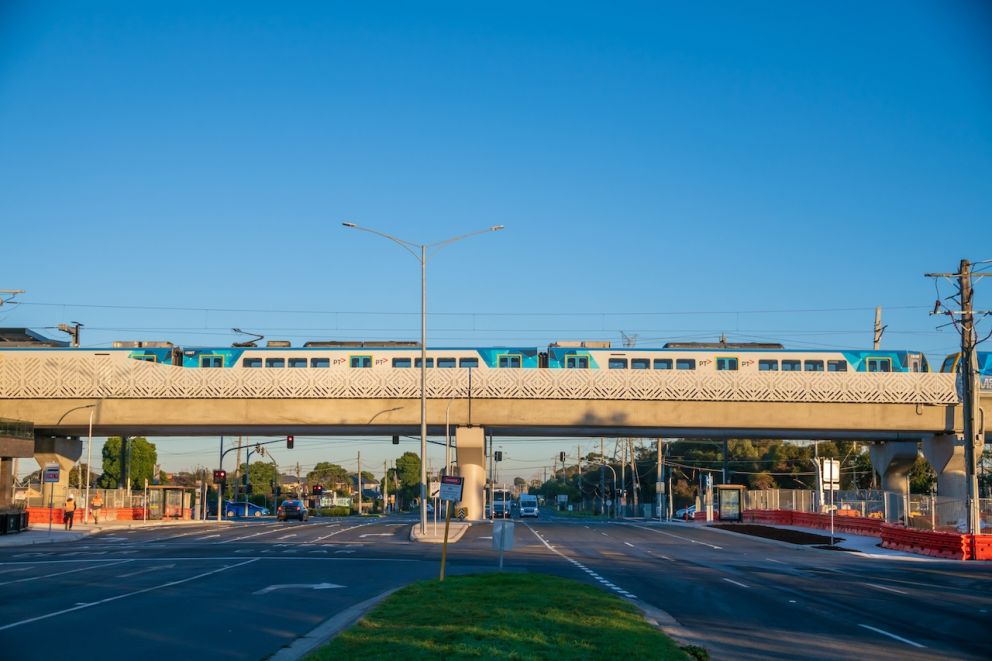 A train passes over Keon Parade