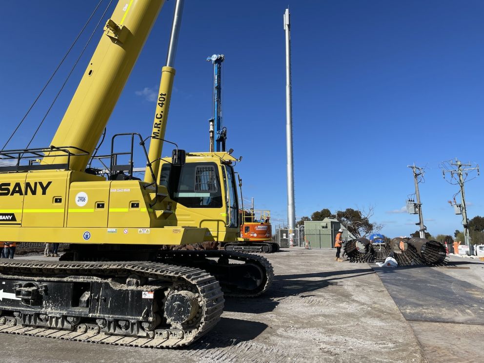 A crane getting ready to drop piling cages into the ground to create the bridge foundations