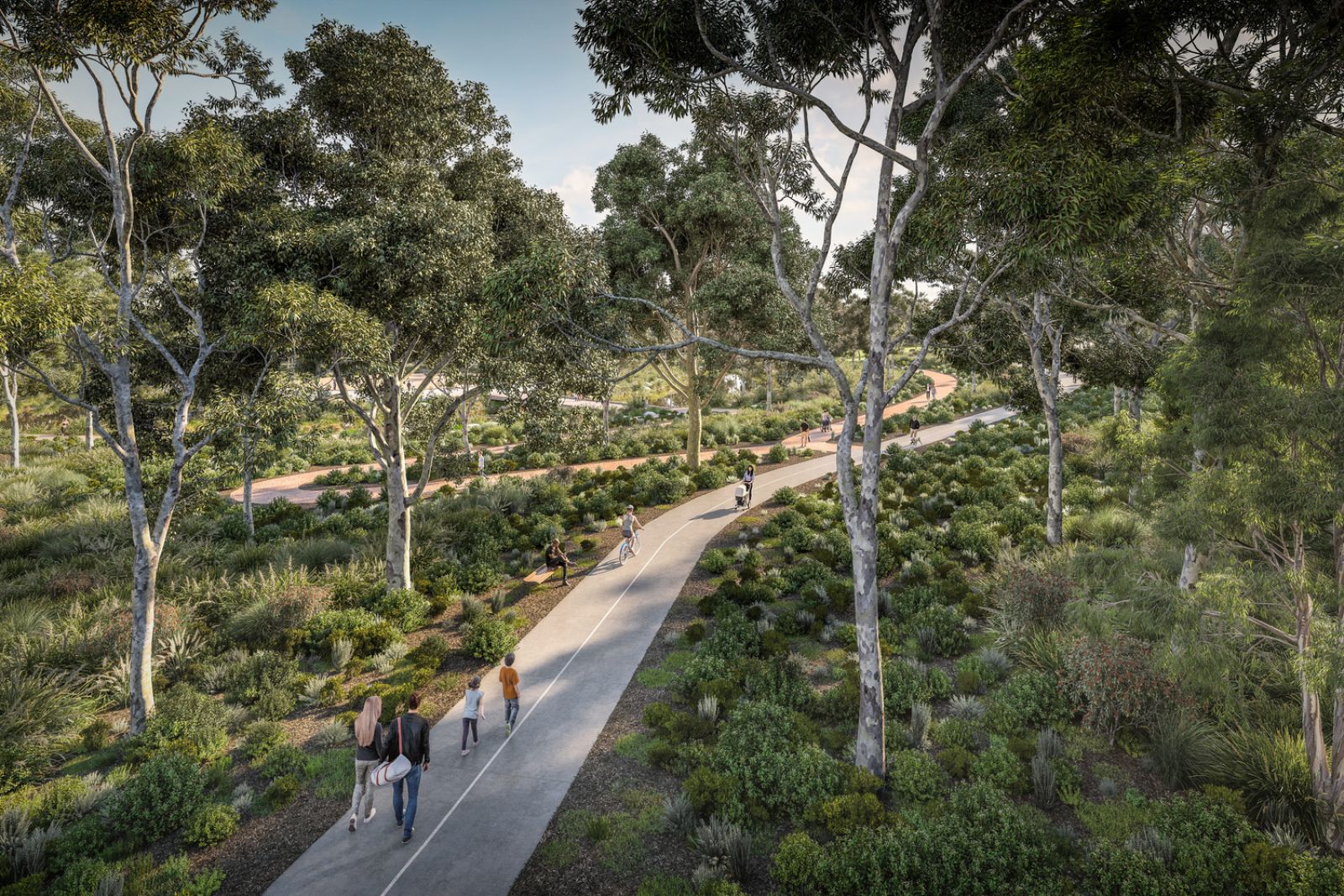 People walking and cycling on a paved path through a lush, green park with tall trees and dense vegetation.