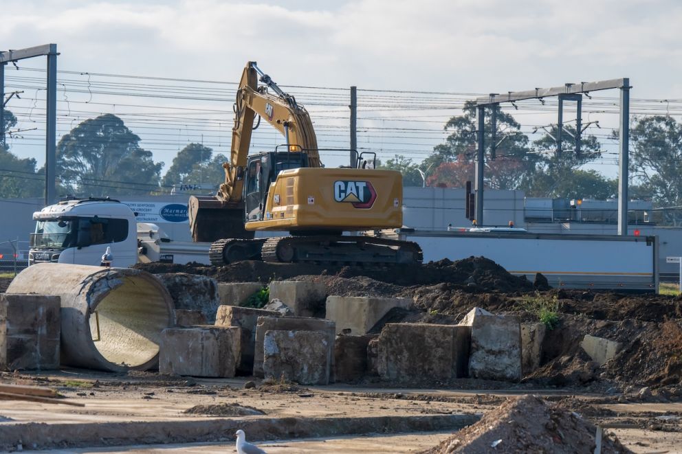 Excavators work to remove soil from the site