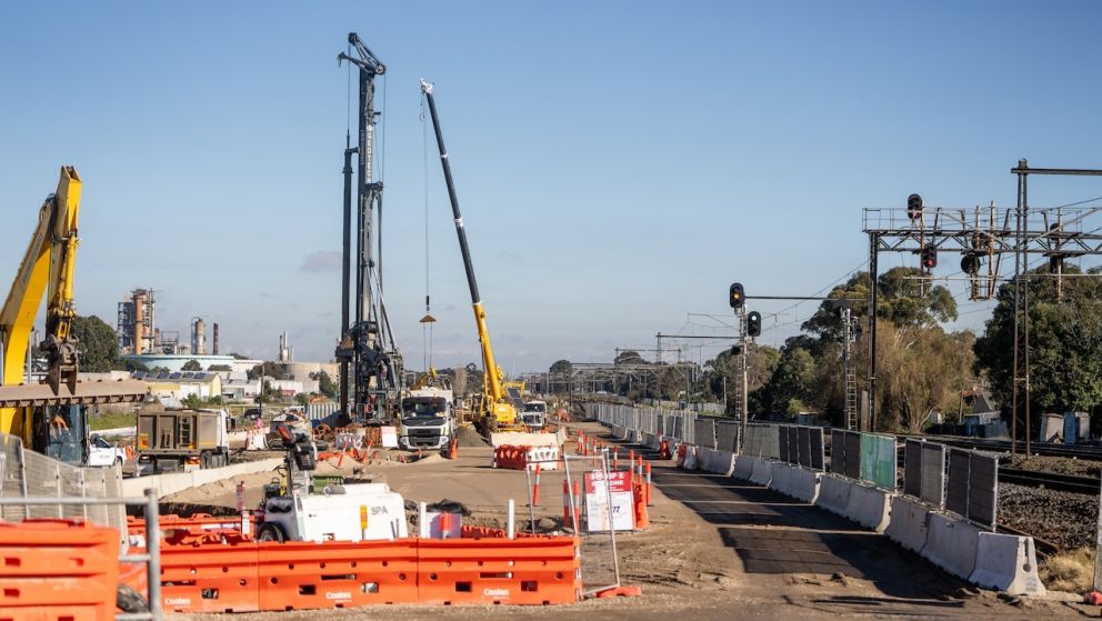 Looking down the Werribee Line as crews get on with piling works for the Newport level crossing removal project