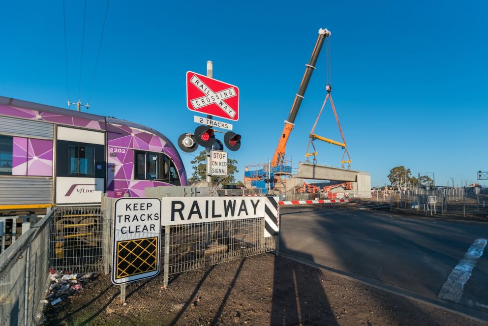 A train travels past the works in Melton