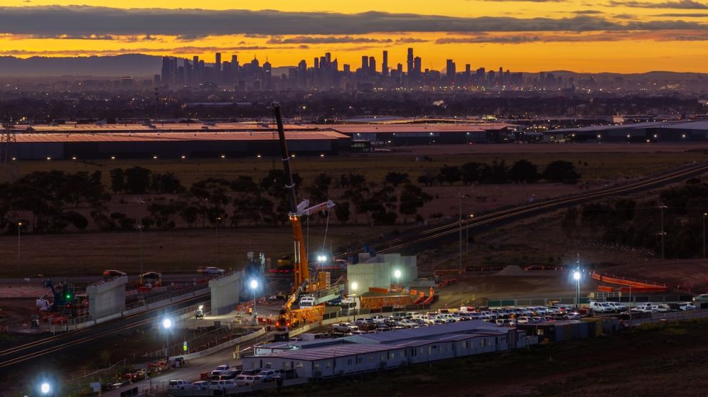 The first beam lift at Hopkins Road gets underway as the sun rises over Melbourne