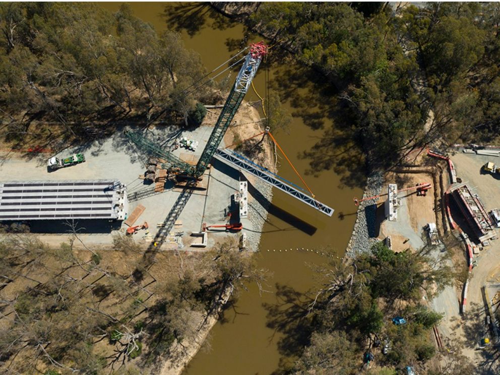 Birds eye view image of a steel beam being lifted into place for the Campaspe River bridge