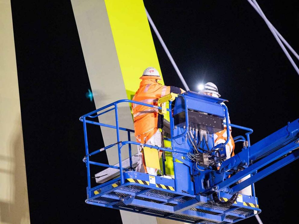 The Blaxland Avenue overpass being painted in the colour 'Kikuyu' which was chosen by the local community.