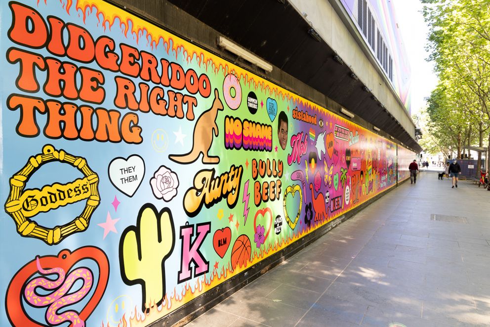 Colourful outside banner artwork featuring queer and indigenous symbols, and typography.