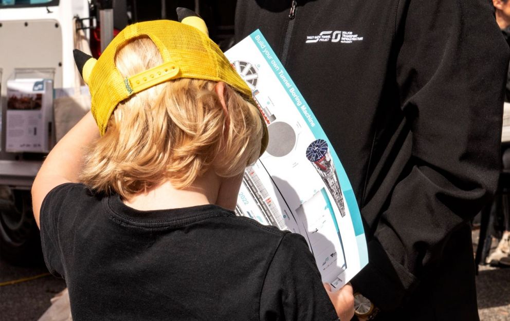 A child reading the instructions to build a cardboard Tunnel Boring Machine.