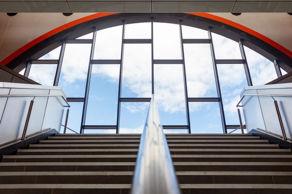 Coburg Station stairwell with the clouds and sky in the large dome window.