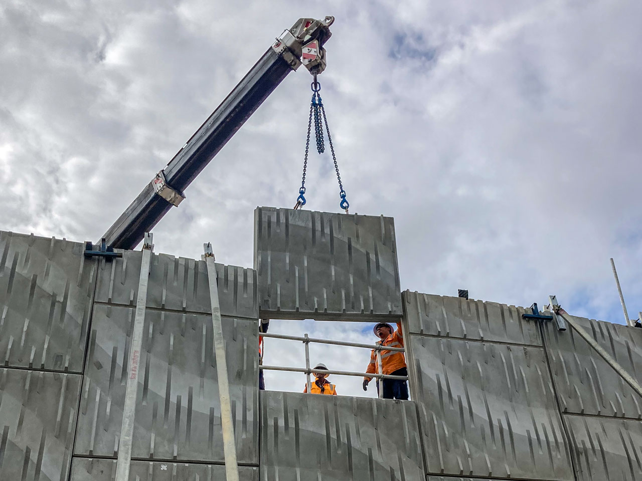 Workers guiding the final panel of the bridge into position on the Fitzgerald Road bridge.