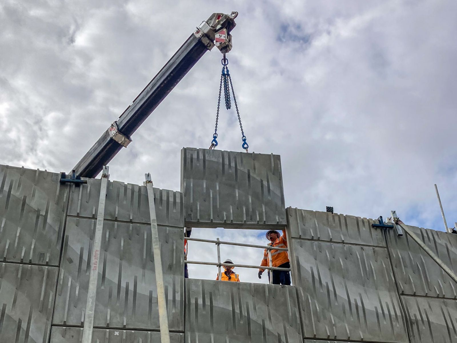 Workers guiding the final panel of the bridge into position on the Fitzgerald Road bridge.