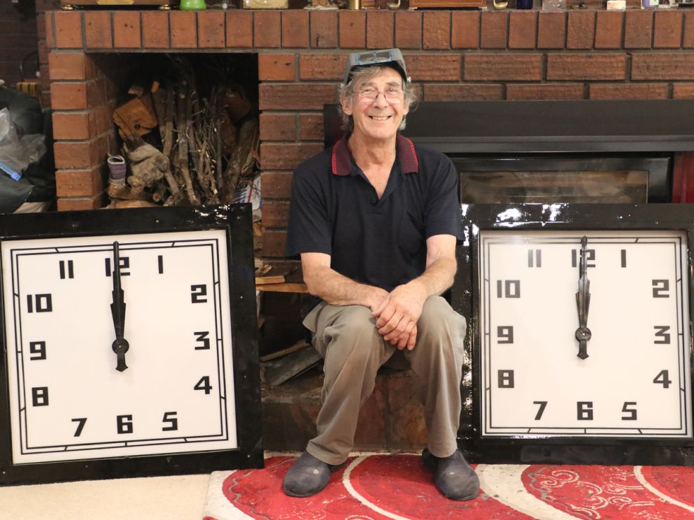 Ron sits with the two Chelsea clock faces.