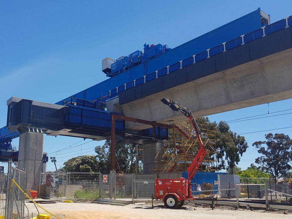 Blue crane over concrete beam.