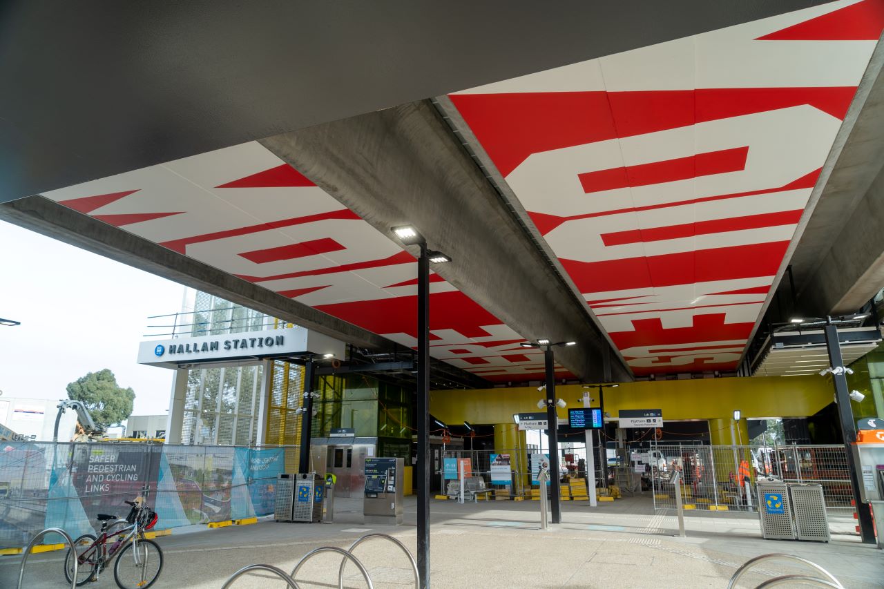 New integrated public artwork at Hallam Station that reads 'You Me Us Here Now