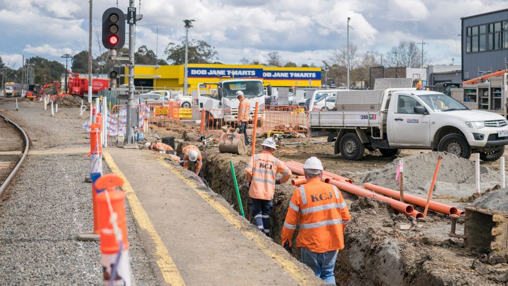Construction workers laying drainage in trench at Traralgon Station