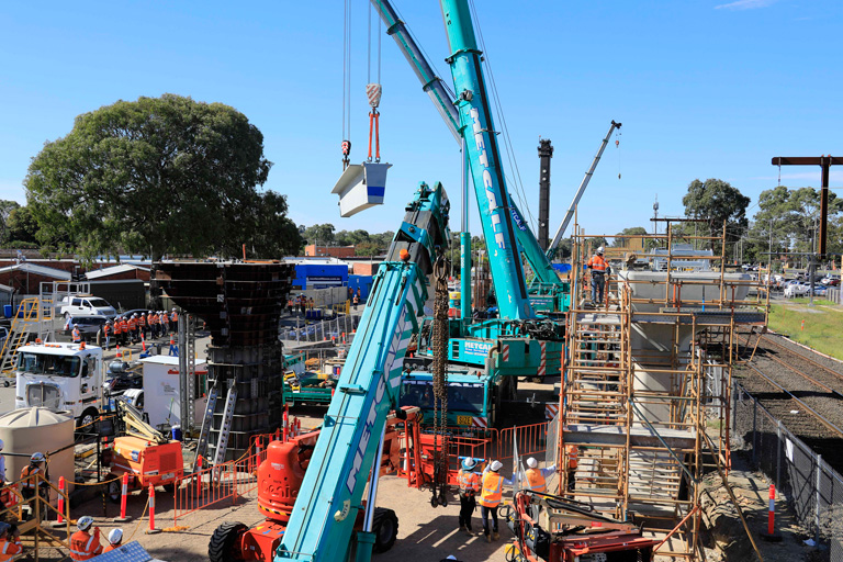 Concrete beam lifted into elevated rail