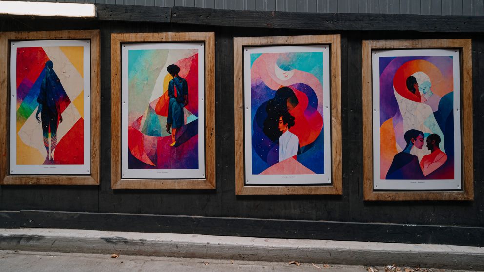 Colourful framed artworks on a Metro Tunnel hoarding wall