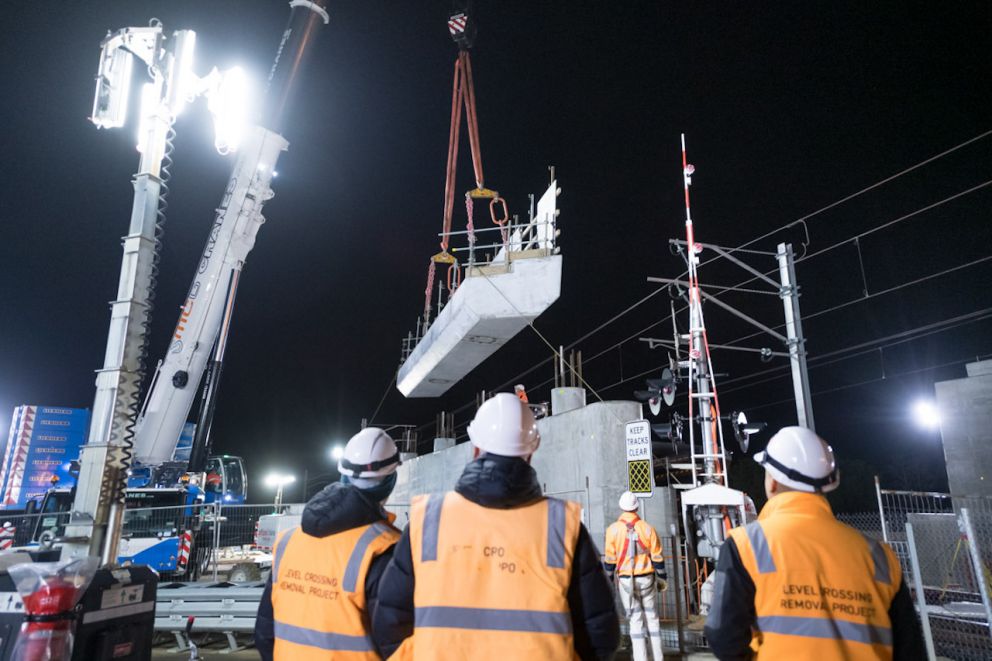 Crews observe the new crosshead segment being lifted into place.