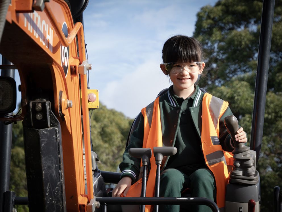 Image shows, Eva a primary school student operating the mini - digger for children