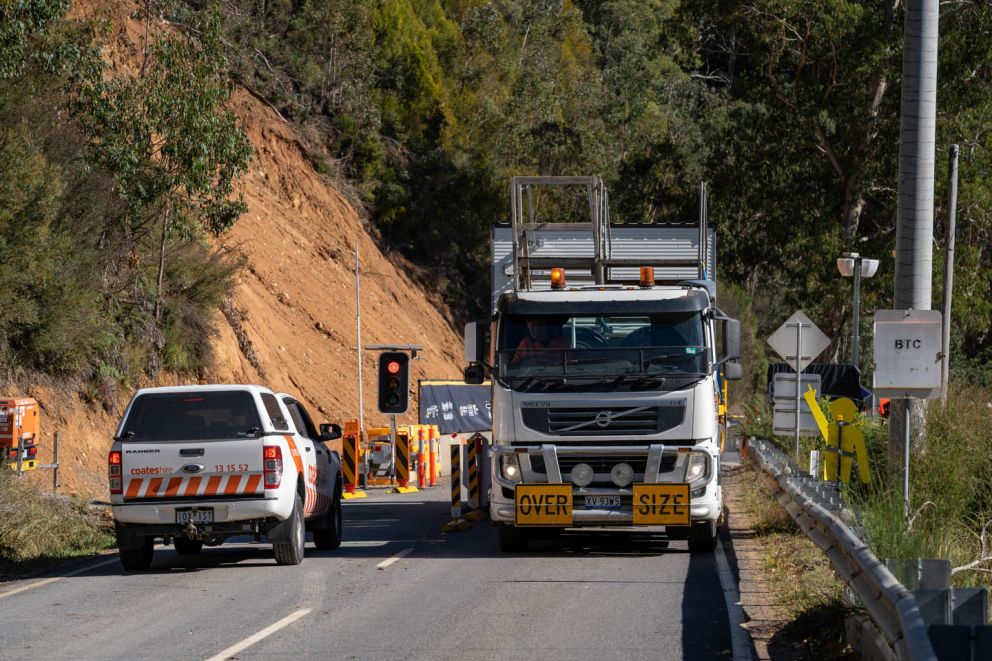 A car and oversize truck passing the Bogong High Plains Rd landslip