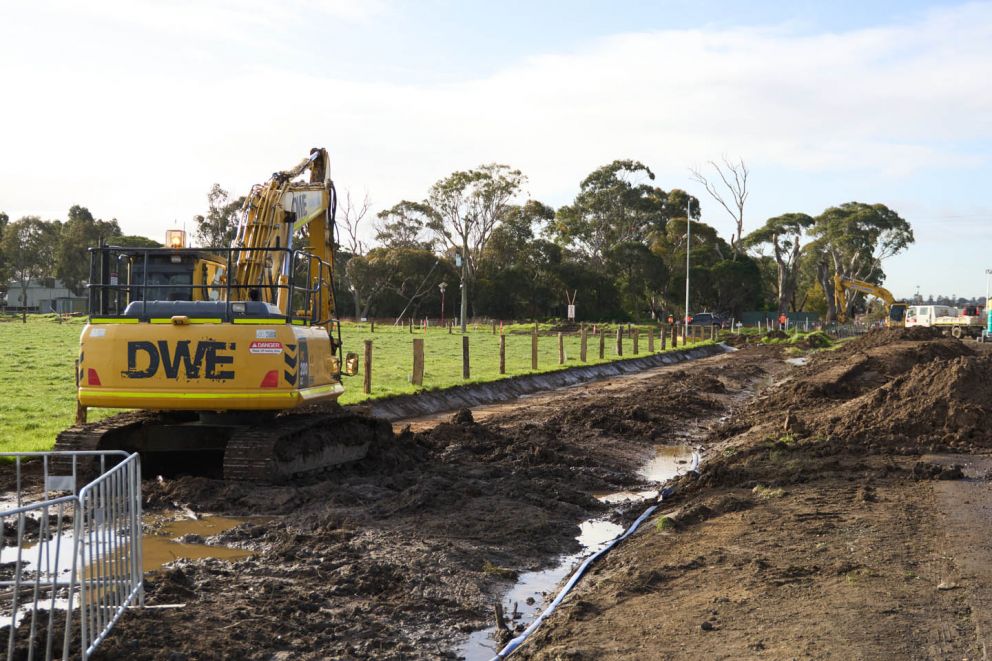 The careful excavation of a channel, soon to transform into a swale drain that will guide stormwater away from Hall Road