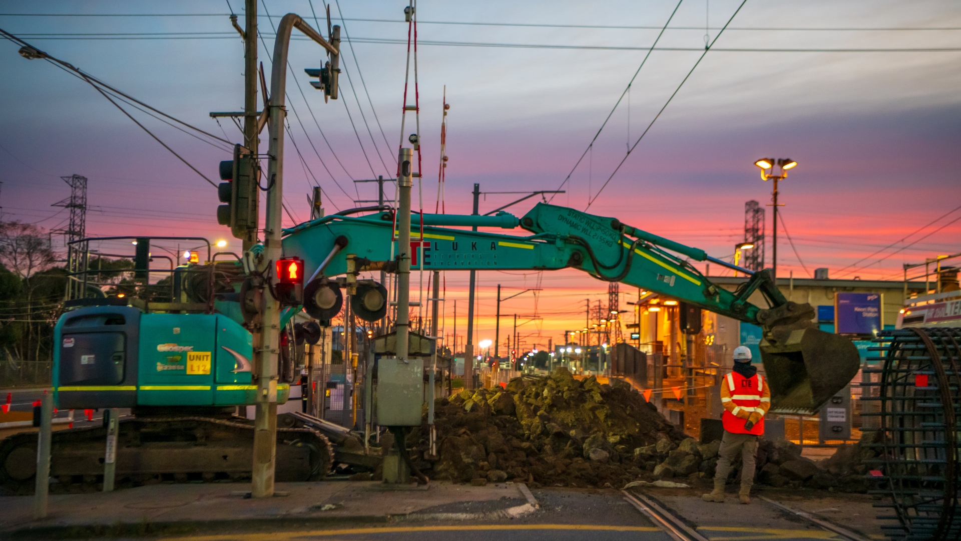 A large excavator works on the level crossing at Keon Park in Reservoir