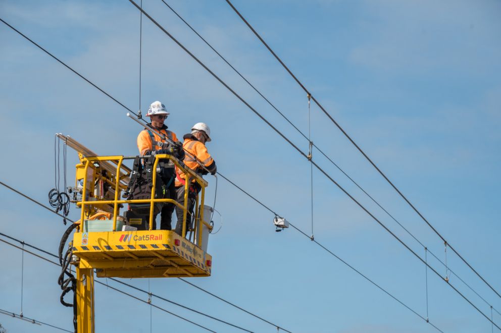 Crews work on the new overhead electrical infrastructure at Kananook Train Stabling Yard