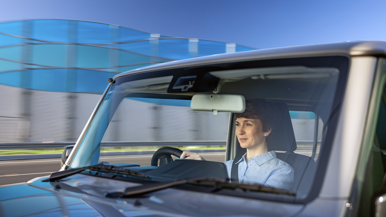 A woman driving along the West Gate Freeway in her car.