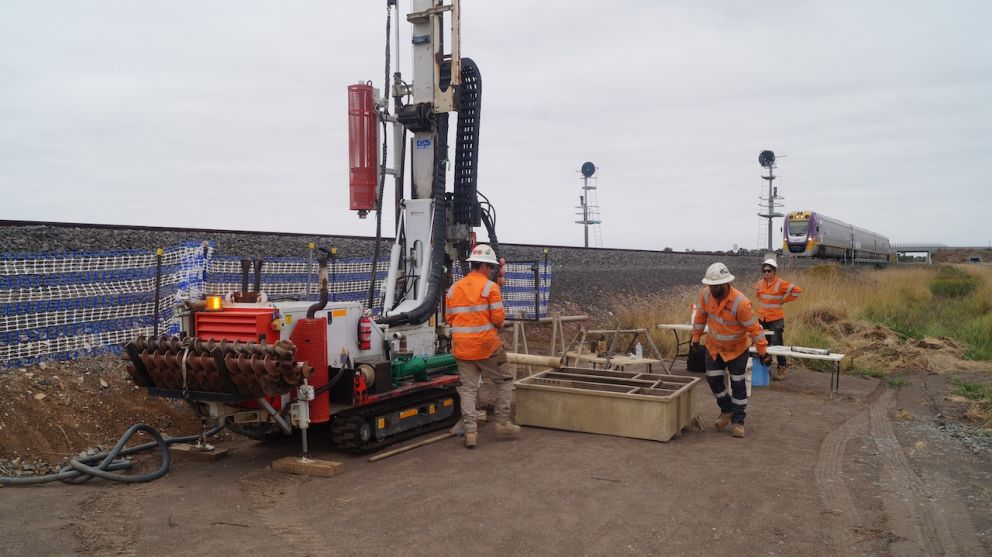 Three workers in orange hi vis doing site investigations