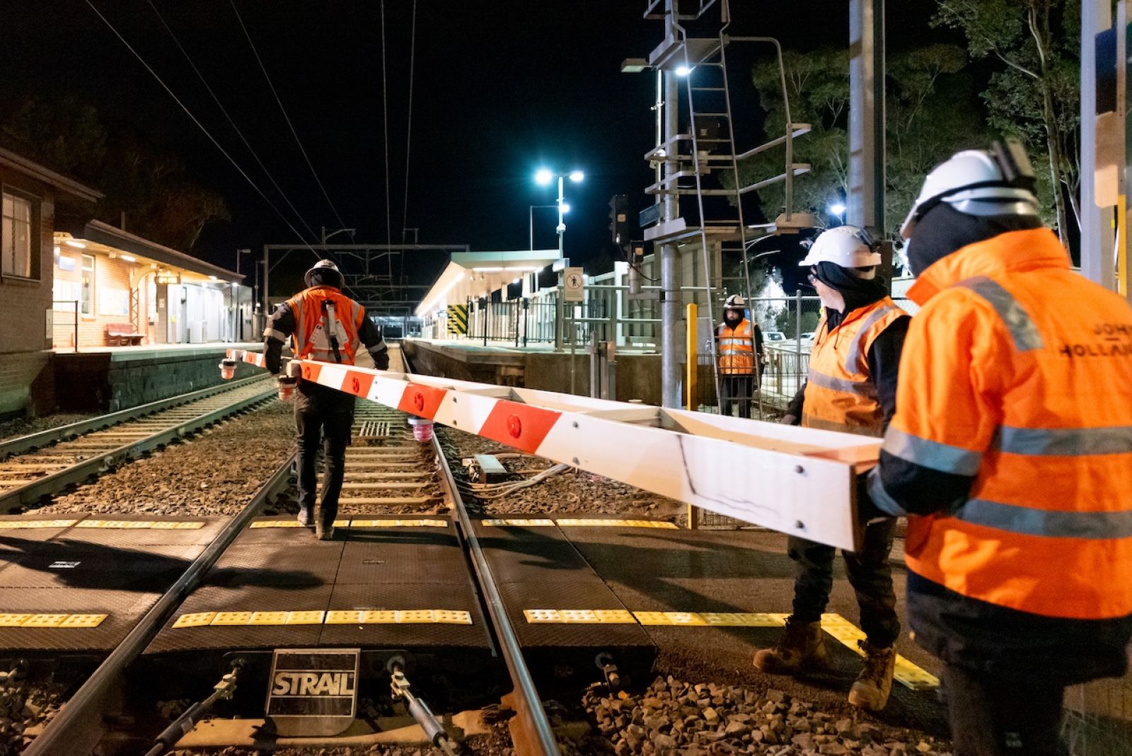 A crew moving the boom gate from the Old Calder Highway level crossing
