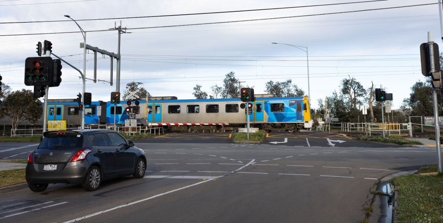 Train passing through the level crossing in Seaford